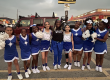 Crescent city schools cheer team posing together with their coach