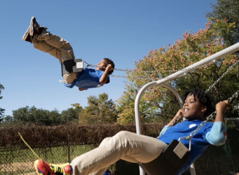 Scholars on swings having a blast